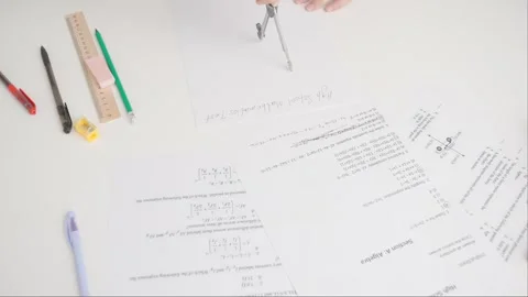 Female draws correct answer in geometry exam test paper with divider. Student Stock Footage 280167424
