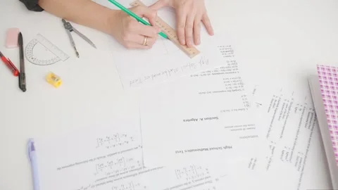 Female draws correct answer in geometry exam test paper with divider and ruler Stock Footage 280167932