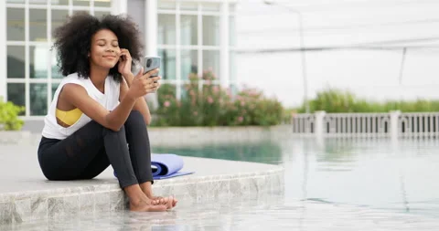 A female dressed for exercise talking smart phone video call. Stock Footage 195282256