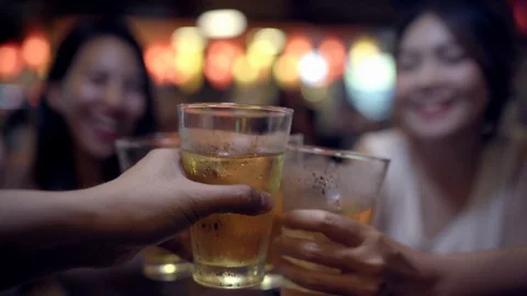Female drinking alcohol or beer with friends and having party. Stock Footage