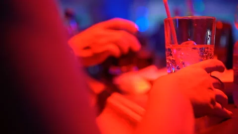 Female drinking cocktail and talking with friend at bar counter in pub, closeup 스톡 동영상 89830516