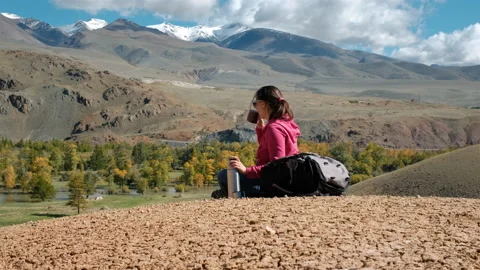 Female Drinking Tea while Hiking around Mountains 스톡 동영상 142261102