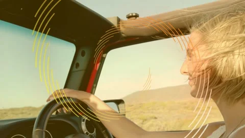Female driver demoing auto steering across desert, breeze lifting hair, rings Stock Footage 333396972