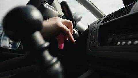 Female driver hand key start a car shift gear woman drive in close up Stock Footage 163359730