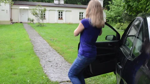 Female driver lady get out from car and run toward house Stock Footage 34348236