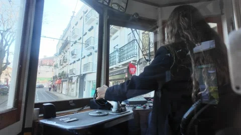 Female driver operating a Lisbon tram Stock Footage 297794075