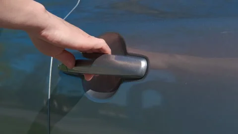 Female driver try locked auto door Stock Footage 314947502