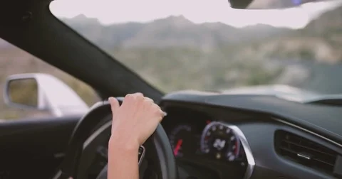 Female driving convertible car on roadtrip Stock Footage