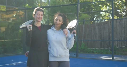 Female duo facing camera in black jacket grey hoodie shifting paddles turning Stock Footage 339496824