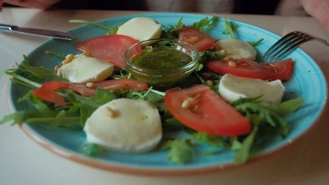 Female eating salad sitting in cafe in city Stock Footage