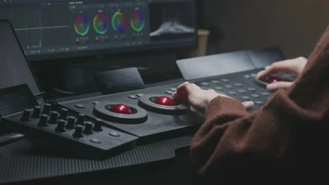 Female editor uses digital color grading control panel Stock Footage 237281176