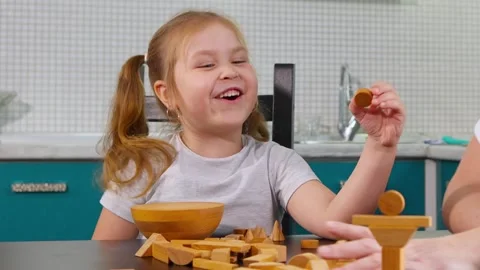 Female educator helping a child build blocks at home Video stock 323709729