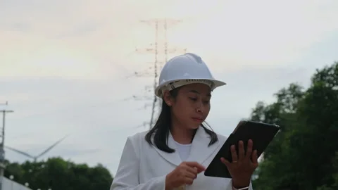Female electrical engineer thumbs up and smiles on wind turbine background. Stock Footage 204970791