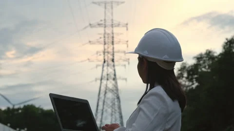 Female electrical engineer working on laptop inspecting power grid. Stock Footage 204970806