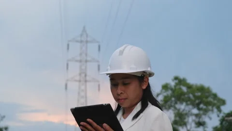 Female electrical engineer working on laptop inspecting power grid. Stock Footage 204971119