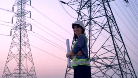 Female electrical engineer working near to High voltage tower. Stock Footage 233283136