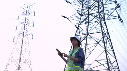 Female electrical engineer working near to High voltage tower. Stock Footage 233283229