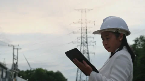 Female electrical engineer working on tablet inspecting power grid. Stock Footage 204970769