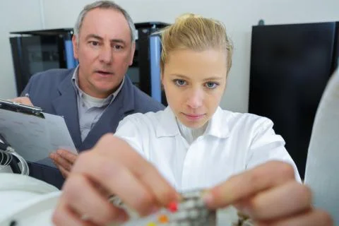 A female electronic apprentice with cables Stock Photos