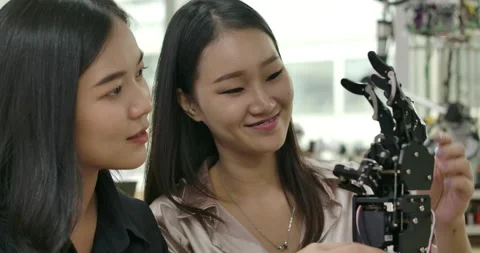 Female electronics engineer building, testing, fixing robotics in laboratory. Stock Footage 152876154