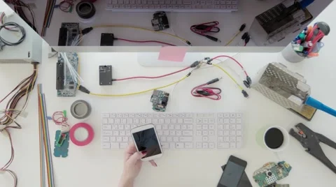 Female electronics engineer using smart mobile phone Stock Footage 63923548