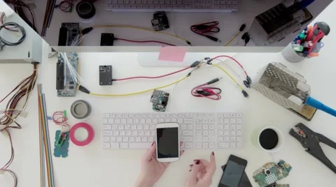 Female electronics engineer using smart mobile phone Stock Footage 63927706