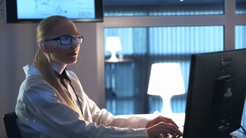 Female electronics engineer working on the computer and writing the results of Stock Footage 112865555