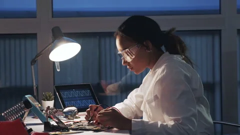 Female electronics engineer working with multimeter tester and other electronic Stock Footage 130231571