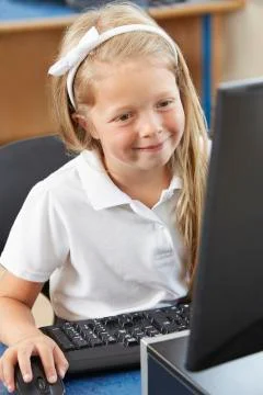 Female elementary school pupil in computer class Stock Photos