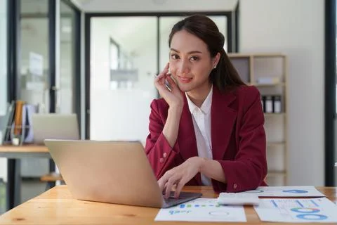 Female employee using laptop at workplace. Businesswoman preparing economic Stock-Fotos