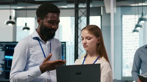 Female engineer and coworker coding AI algorithms to debug software issues Stock Footage 313016176