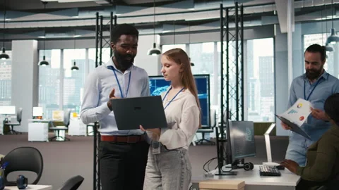 Female engineer and coworker coding AI algorithms to debug software issues Stock Footage 313165124