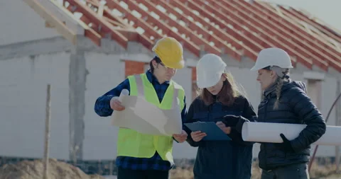Female engineer and supervisor discussing over blueprint with coworker Video stock 187025376
