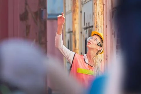 Female engineer checking containers box with from cargo container Photos