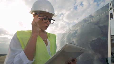 Female engineer checking sun batteries on a roof. Modern innovative industry Stock Footage 96253113