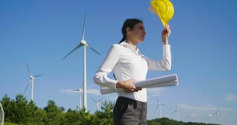 A female engineer is controlling a functioning of wind turbines. Stock Footage 115124506