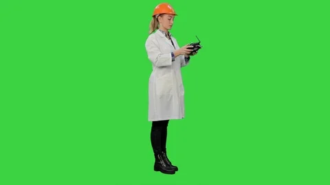Female engineer correct parts of an object using remote controller on a Green 動画素材 73863684