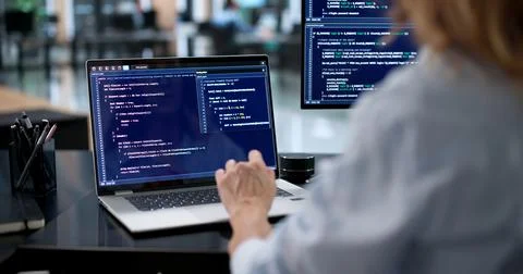 Female Engineer Creating Secure Software Code On Laptop Screen 스톡 사진