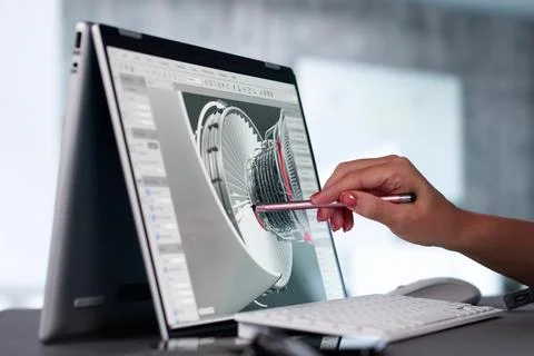 Female Engineer Developing Mechanical Parts Using 3D CAD Software On Laptop 写真素材