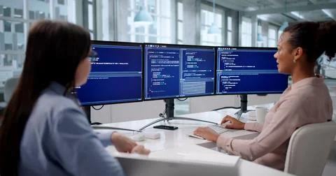 Female Engineer Developing Software On Multiple Computer Screens In Business  Stock Photos
