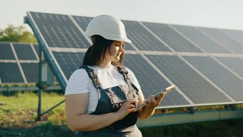Female engineer with digital tablet working at a power plant with solar panels Stock Footage 251485186