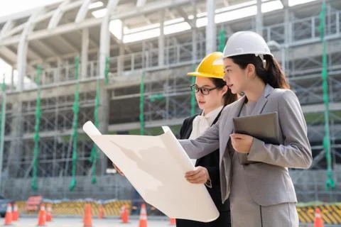 Female engineer displaying a building plan. 스톡 사진