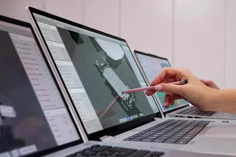 Female Engineer Drafting Electric Car Parts On Laptop Computer Screen 写真素材