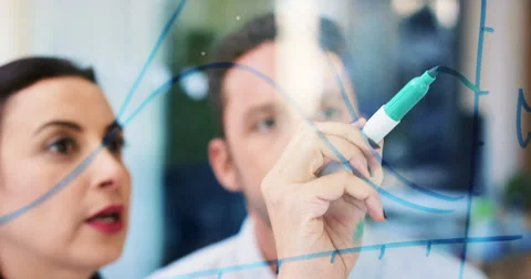 Female engineer drawing graph on glass showing student mathematical formula in Stock-Footage 59145422