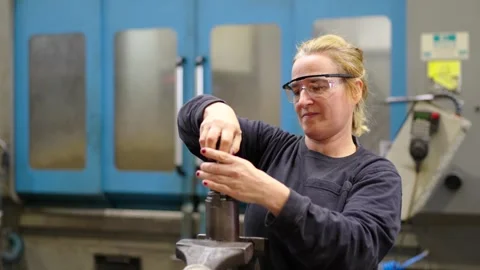 A female engineer fixing a industrial machine Stock Footage 258805576