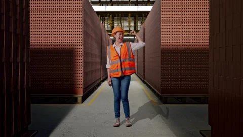 Female Engineer Flexing Her Bicep And Smiling With Brick In Stacks Stock Footage 303763119