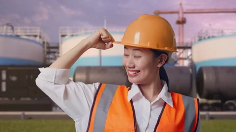 Female Engineer Flexing Her Bicep And Smiling at Oil Refinery Stock Footage 340143770