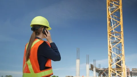 Female Engineer gets Cell Phone Call at Construction Site, 4k Stock Footage 109464167