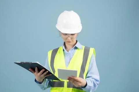 Female Engineer in Hard Hat and Safety Vest Holding Clipboard Stock Photos