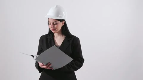 Female Engineer in Hard Hat Reviewing Folder Documents Stock Footage 346229833